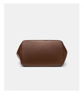 Detailed bottom view of the large brown leather bag showing premium texture and clean finish.