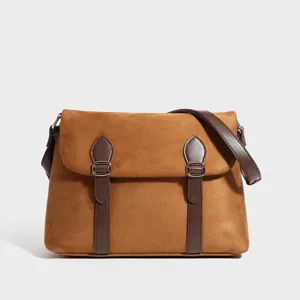 Vintage brown suede messenger bag with dark leather buckle straps, chic retro shoulder bag.