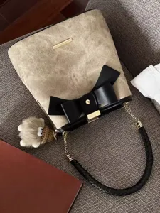 Chic bow bucket bag for women, luxury style PU leather handbag and crossbody bag.