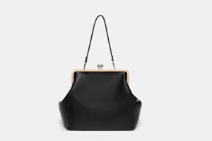 Large black kiss-lock handbag with metal frame, elegant evening shoulder bag for women.