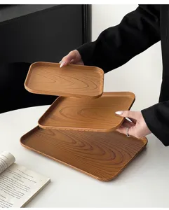 Detail shot of rectangular plastic serving trays with wood grain texture, stacked elegantly.