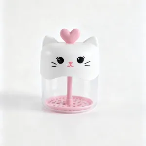Cute cat facial cleanser foamer detail view, transparent cup with pink foaming stick.