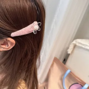 Sweet pink glitter hair clip featuring a clear acrylic flower and pearl center for daily wear.