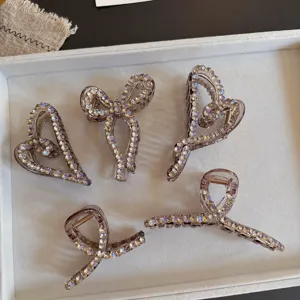 Sparkling rhinestone hair claw detail view, gorgeous crystal bow and heart shark clip.