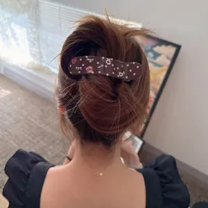 Korean acetate polka dot hair claw clip detail shot, elegant large barrette for bun styling.