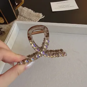 Stunning purple rhinestone hair claw clip with delicate bow design, sparkling crystal hair accessory.