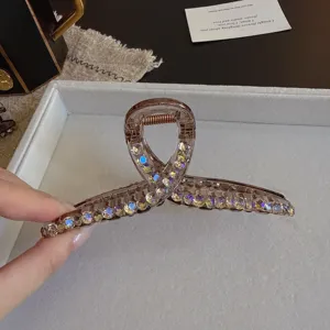 Detailed close-up of a sparkling purple rhinestone hair claw clip with exquisite bow design.