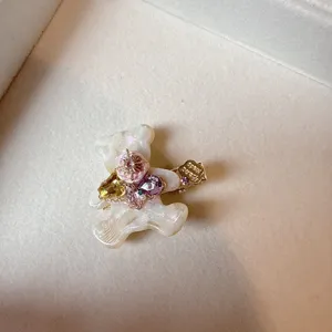 Sweet acetate bear hair clip with rhinestones and duckbill design for side hair styling.