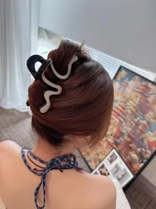 Stylish rhinestone snake hair claw clip for women, elegant back head hair updo accessory.
