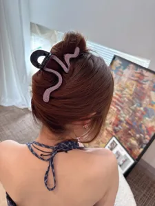 Rhinestone snake hair claw clip detail shot, elegant back hair styling accessory for women.