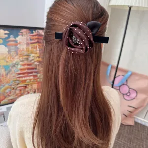 Vintage fabric rose rhinestone hair clip with polka dots and elegant black velvet barrette design.