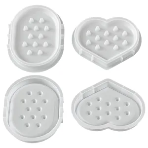 Detailed view of heart-shaped and oval silicone molds for DIY jewelry storage trays casting.