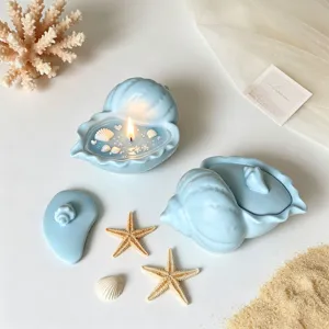 Blue shell shaped storage jar and scented candle cup with lid, coastal decor detail.