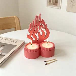 Pink double cup candle holder with flame design, minimalist tabletop decor detail view.