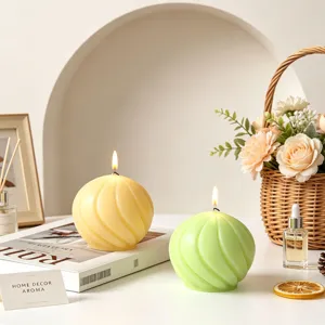 Detailed shot of spherical spiral scented candles in yellow and green, perfect for home decor.