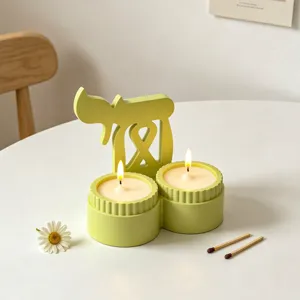 Light green double cup scented candle holder with unique symbolic design, perfect for home decor.