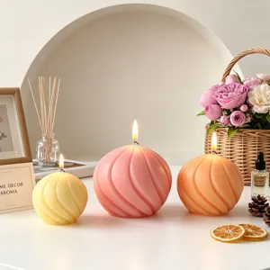 Spherical spiral scented candles set, large, medium, small sizes, warm home decor setup.