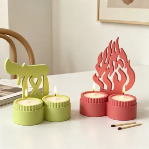 Double cup scented candle holder set with creative flame and symbol backings for desktop decor.