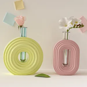 Modern Nordic style aesthetic round and oval ring ceramic vases with test tube flower arrangement.