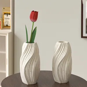 Modern white twisted wavy ceramic vase set for home decor, elegant tabletop floral arrangement container.