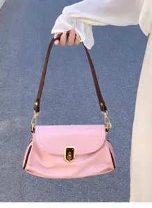 Close-up detail of rose pink soft leather shoulder bag with brown strap and metallic lock.