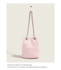 Pink quilted bucket bag with chain strap, stylish leather shoulder bag for women daily commute.