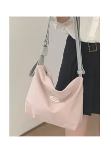 Detail shot of a pink shoulder hobo bag with contrast blue strap and branded badge.