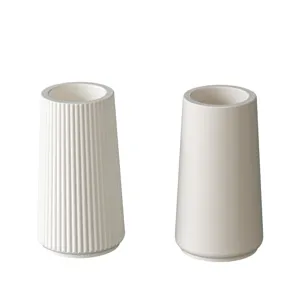 White silicone mold set featuring detailed vertical stripes and smooth conical candle cup design.