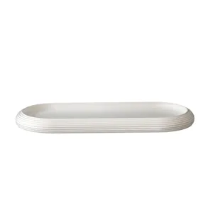 Minimalist white oval striped tray detail view, elegant textured decorative dish for home decor.
