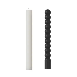 Minimalist long pillar candles featuring striped and bubble sphere designs for modern home decor.