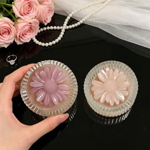 Close-up detail of the decorative daisy candle cup with striped design in a elegant scene.