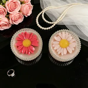 Close-up of cute daisy scented candles in striped glass jars, ideal for home decor and gifts.
