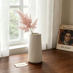 White striped ceramic vase with pink flowers, elegant modern tabletop home decor for living room.