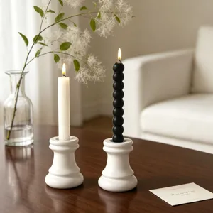 Minimalist ceramic candle holder with scented pillar candles for home decor and cozy ambiance.