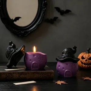 Detail shot of Halloween witch hat house candle jar with spider web relief, spooky aroma decor.