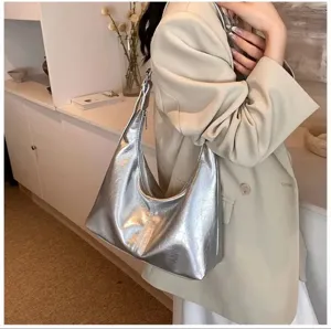 Glacier silver soft leather underarm shoulder bag detail showing glossy surface texture.