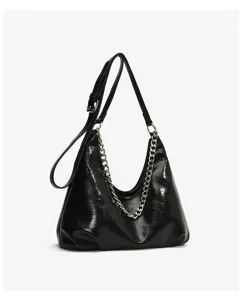 Detailed view of the black glossy shoulder bag featuring stylish silver chain and strap.