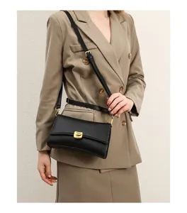 Black chic shoulder baguette bag detail, premium metal clasp design, stylish urban daily wear.