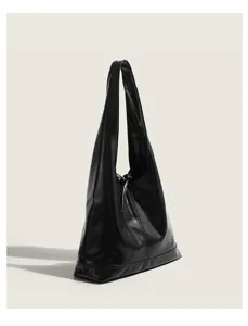 Black minimalist leather shoulder bag detail shot showcasing sleek design and texture.