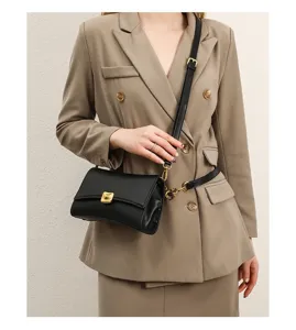 Elegant black shoulder bag for women, stylish underarm baguette bag with chic gold hardware.