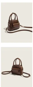 Detail view of the retro brown leather women crossbody handbag with top handle and front pocket.