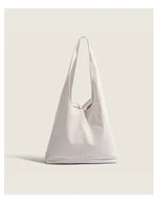 Close-up detail of smooth glossy off-white minimalist shoulder tote bag daily commuter style.