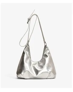 Silver metallic shoulder bag detail featuring soft slouchy leather and sleek metal chain.