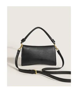 Black leather underarm baguette bag, elegant shoulder handbag with metallic hardware.