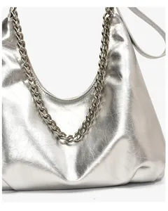 Detailed view of silver metallic chain shoulder bag with textured fabric and strap.