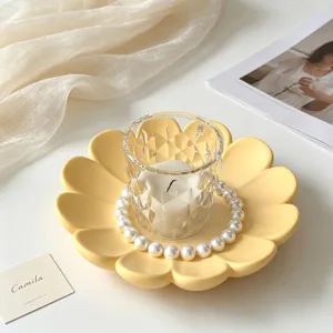 Yellow flower petal silicone tray with glass candle holder and pearl decor details.