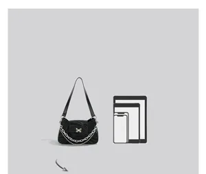 Black baguette shoulder bag detail showing inner capacity and stylish metal chain strap design.