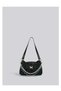 Stylish black shoulder bag with metal bow and chain decoration for women daily commuting fashion.