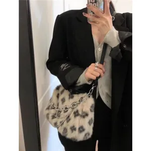 Detailed close-up view of trendy leopard print plush shoulder bag with soft fur.