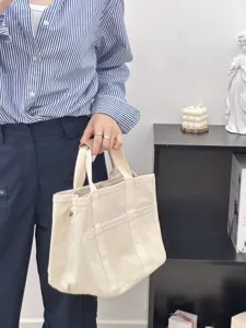 Close-up view of the durable canvas tote bag showing sturdy handles and compartments.